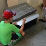 90-foot stone and a boy trying to decipher it
